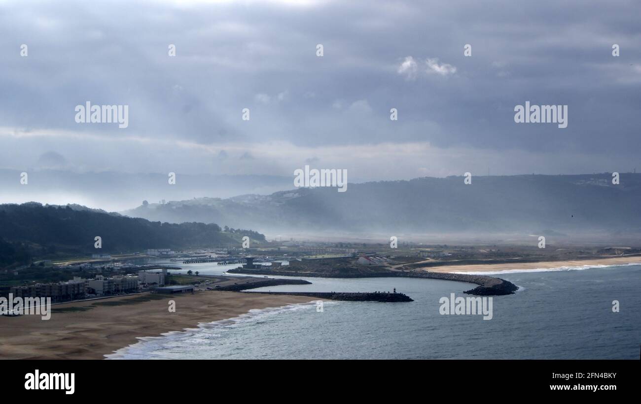 Plage de Nazarè, Portugal, vue de dessus. Magnifique plage portugaise par une journée nuageuse de printemps. Village de pêcheurs et pèlerinage religieux. Banque D'Images