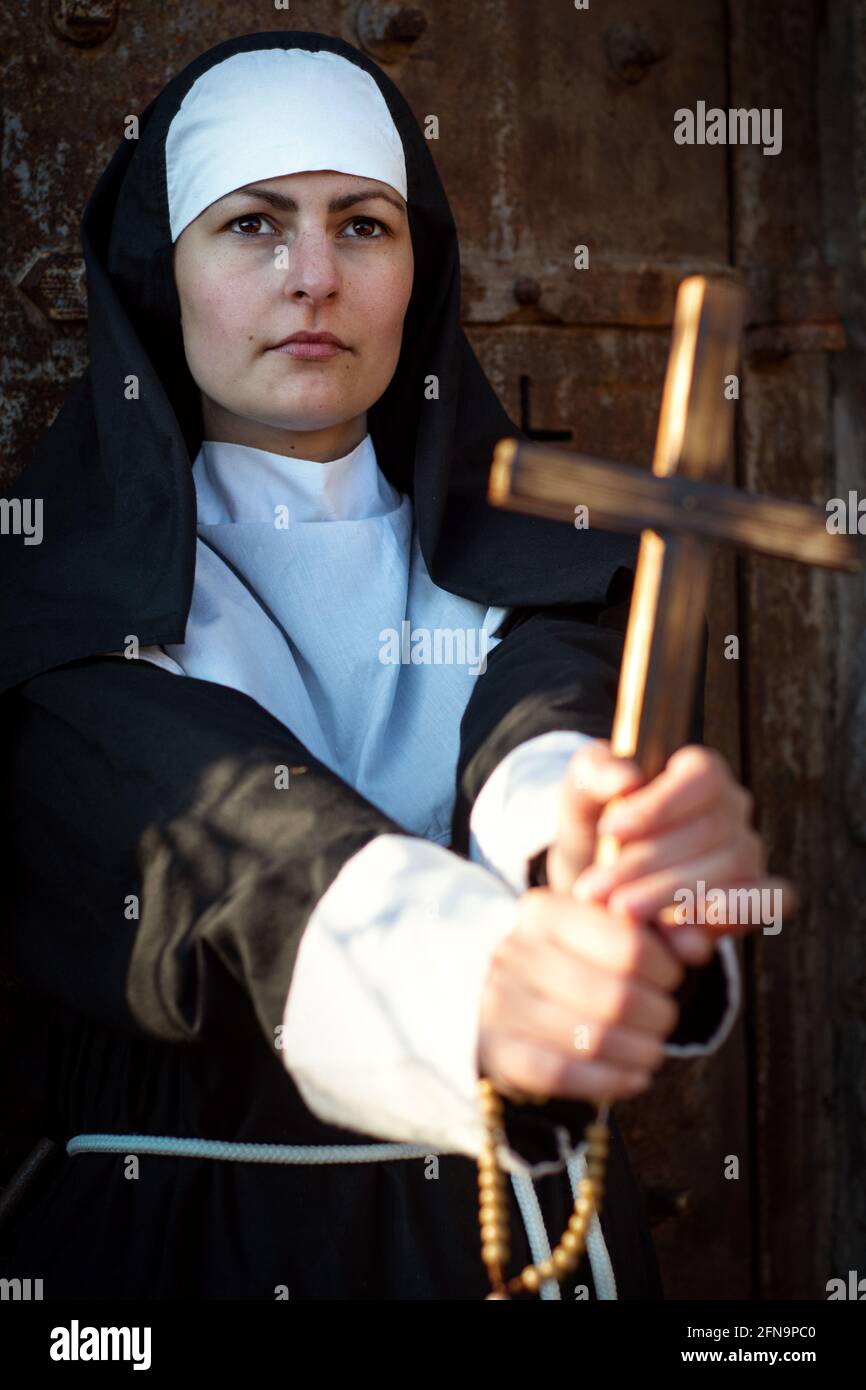 Jeune énergique, nonne arragée montre la croix Banque D'Images