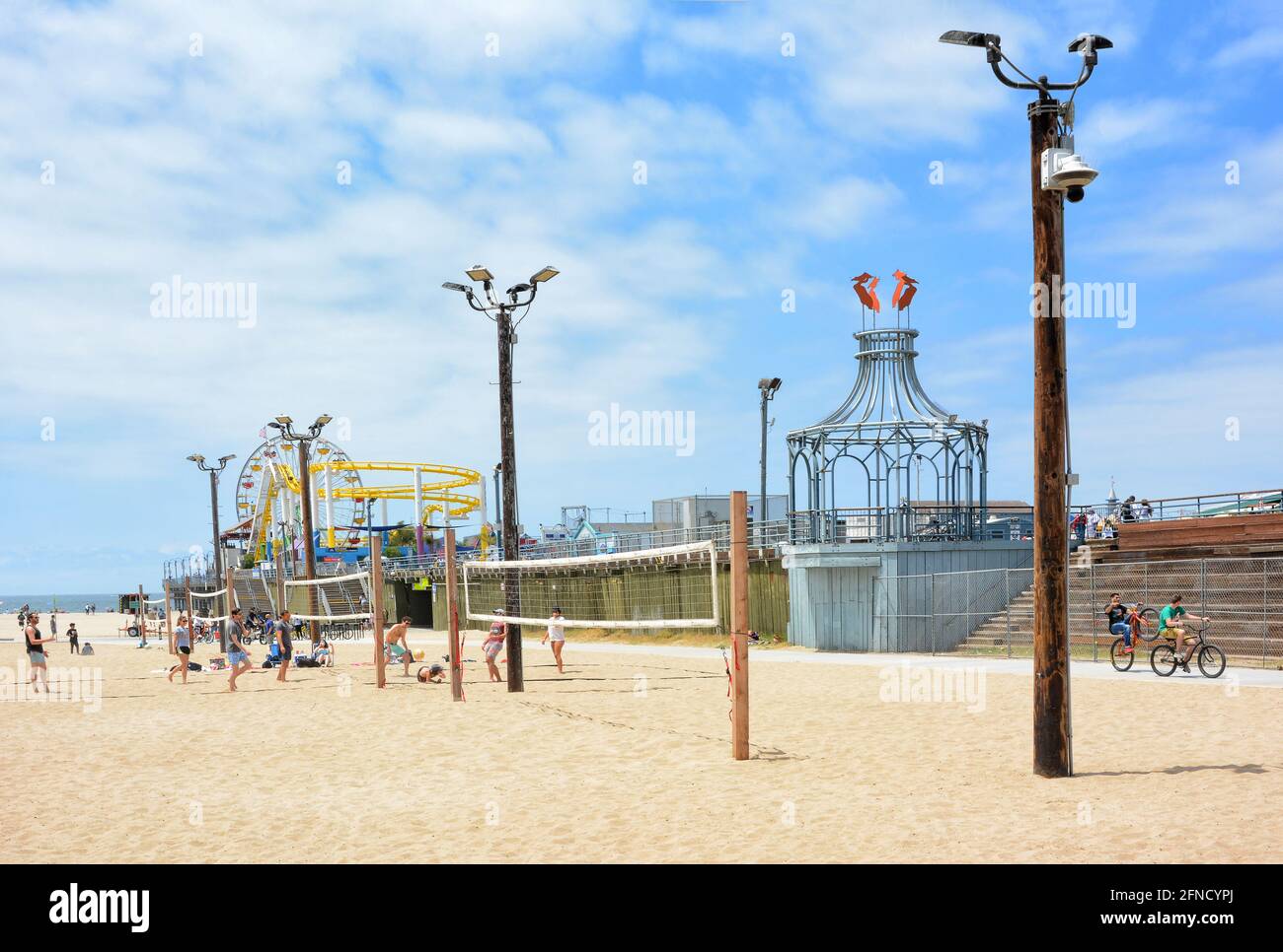 SANTA MONICA, CALIFORNIE - 15 MAI 2021 : terrains de volley-ball de plage avec terrain de jeu sur la jetée et Pacific Park en arrière-plan. Banque D'Images