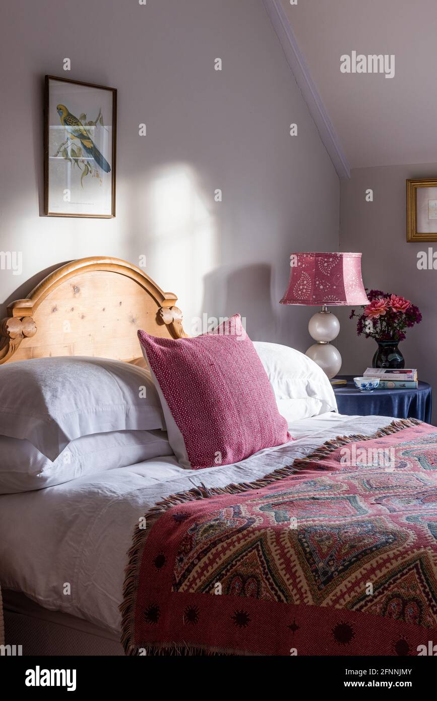Couverture tapisserie sur lit double éclairé dans un cottage victorien du XIXe siècle. Banque D'Images
