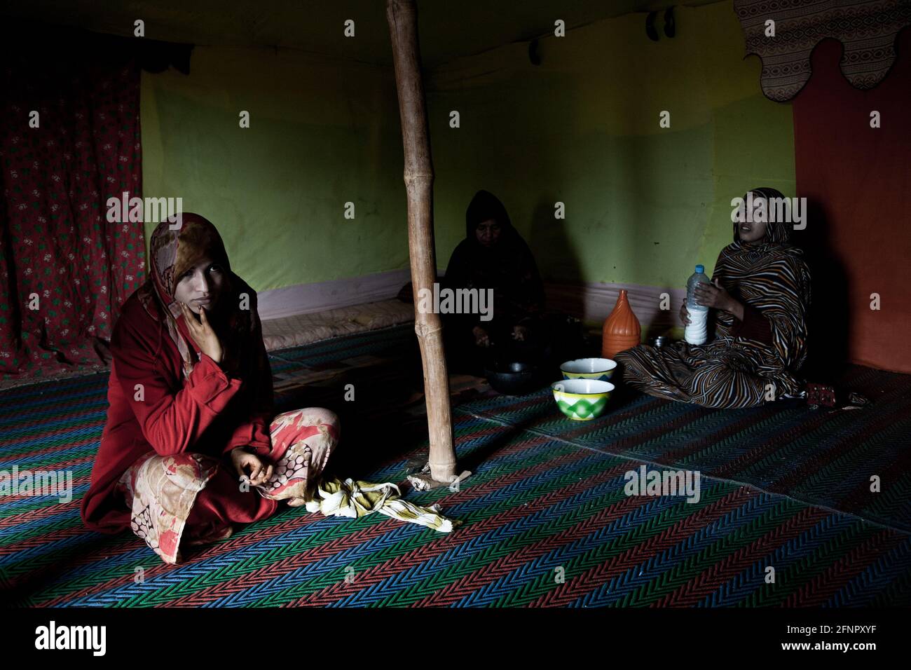 Territoires libérés, Sahara occidental. Les femmes de Beduin dans leur jaima (tente), préparant un rafraîchissement pour les visitorateurs (lait de chameau mélangé à de l'eau). Banque D'Images
