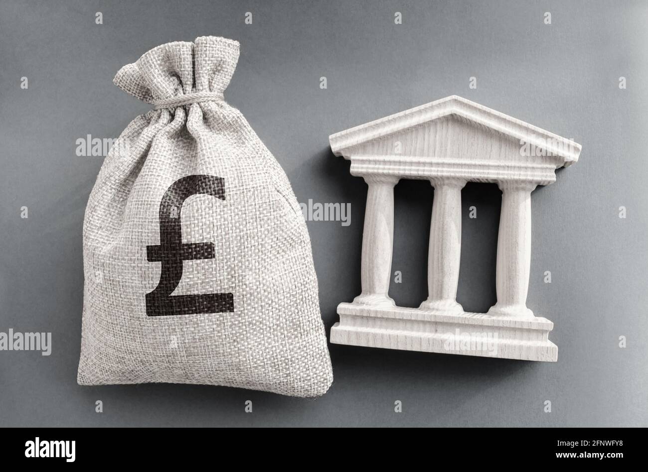Livre sterling sac d'argent et bâtiment du gouvernement. Concept commercial et financier. Dépôt, prêt et investissement dans la banque. Crédit. Aide du sta Banque D'Images