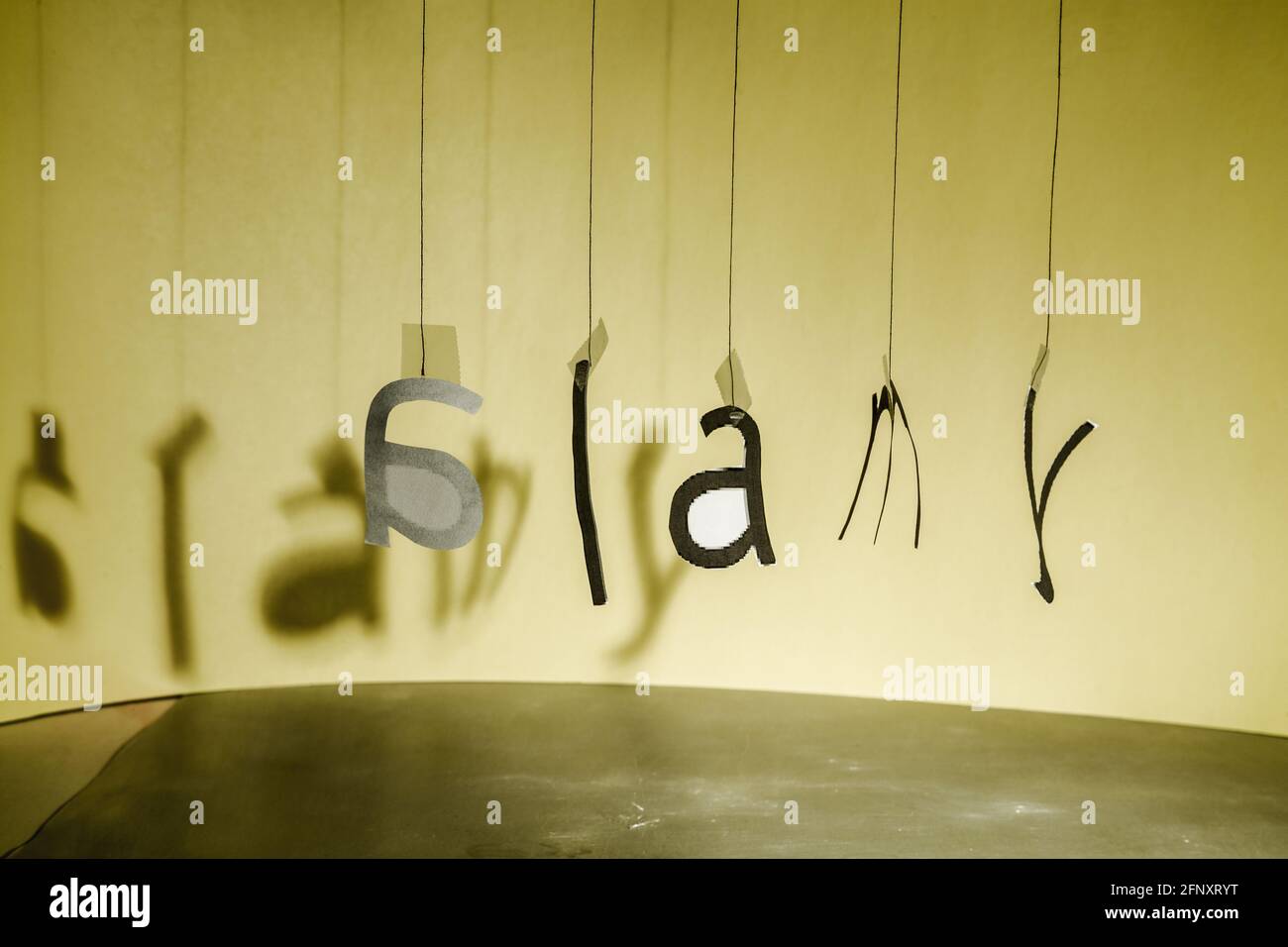 Les lettres accrochées à des fils forment, dans un certain désordre, le logo Alamy. Banque D'Images