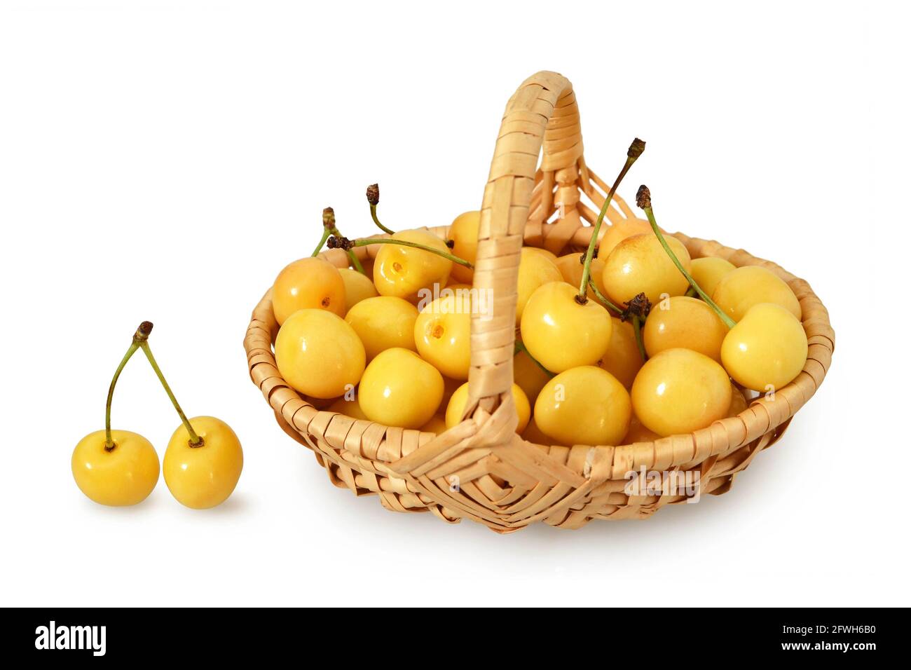 Cerises jaunes dans le panier isolées sur fond blanc Banque D'Images