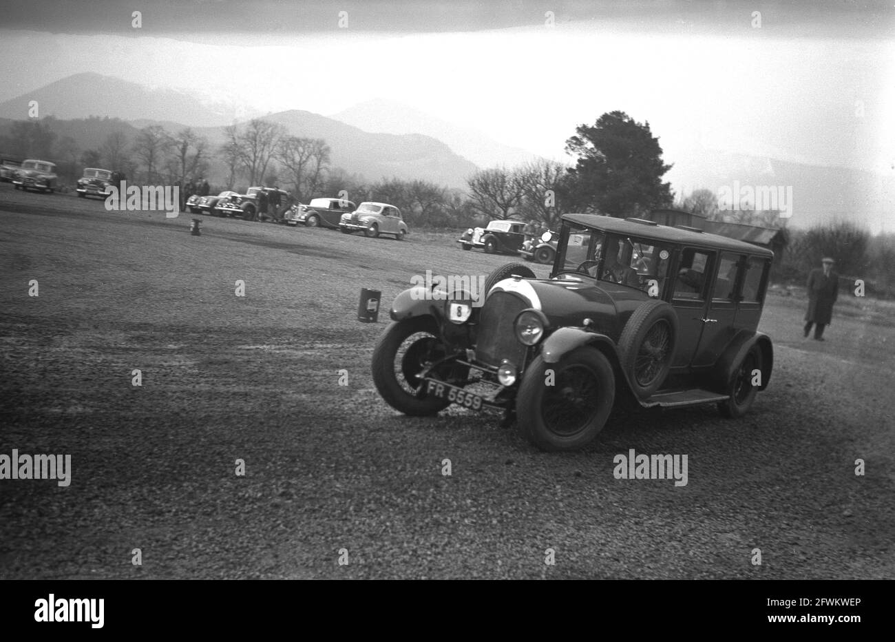 1949, historique, une voiture Alvis participant à un événement d'essais de club automobile sur une grande surface plate de gravier, Angleterre, Royaume-Uni. Ce type d'événement tout-terrain a permis aux propriétaires de voitures et aux passionnés de voitures de se rencontrer et de tester leurs propres compétences de conduite ainsi que la fiabilité et la maniabilité de leur véhicule. Alvis, un constructeur automobile et d'ingénierie britannique de Coventry, en Angleterre, a commencé en 1919 sous le nom de T.G John & Co, devenant la Alvis car & Engineering Company en 192. Le modèle vu ici est le 1930 12/50 Alvis Silver Eagle, peut-être le modèle Sportsman. Banque D'Images