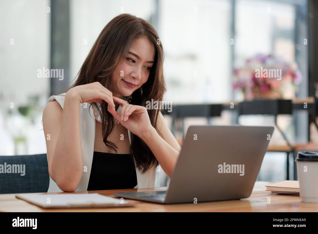 Portrait d'une femme d'affaires asiatique attrayante travaillant avec un ordinateur portable pour une conférence de groupe en ligne, Banque D'Images