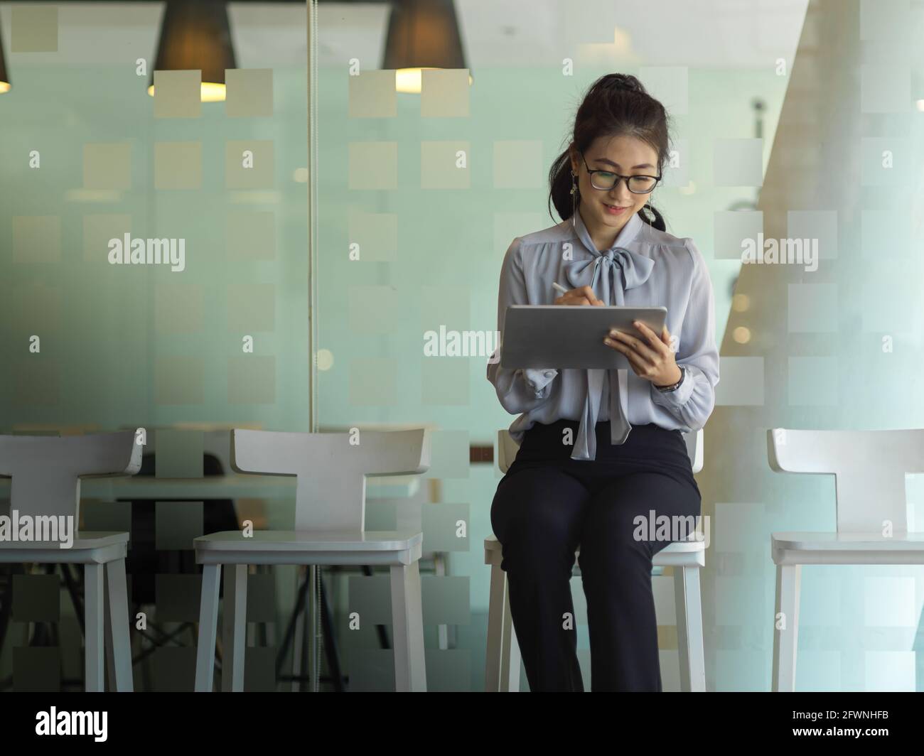 Portrait d'une femme d'affaires travaillant avec une tablette numérique ...
