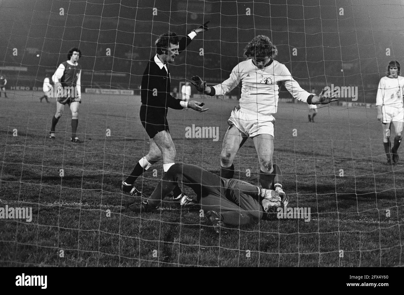 FC Amsterdam contre FC Koln 2-3 ( UEFA Cup ); Jansen (debout) coups gardien Schumacher, arbitre gauche Thomas, Schumacher blessé le 19 mars 1975, sport, football, pays-Bas, agence de presse du xxe siècle photo, nouvelles à retenir, documentaire, photographie historique 1945-1990, histoires visuelles, L'histoire humaine du XXe siècle, immortaliser des moments dans le temps Banque D'Images