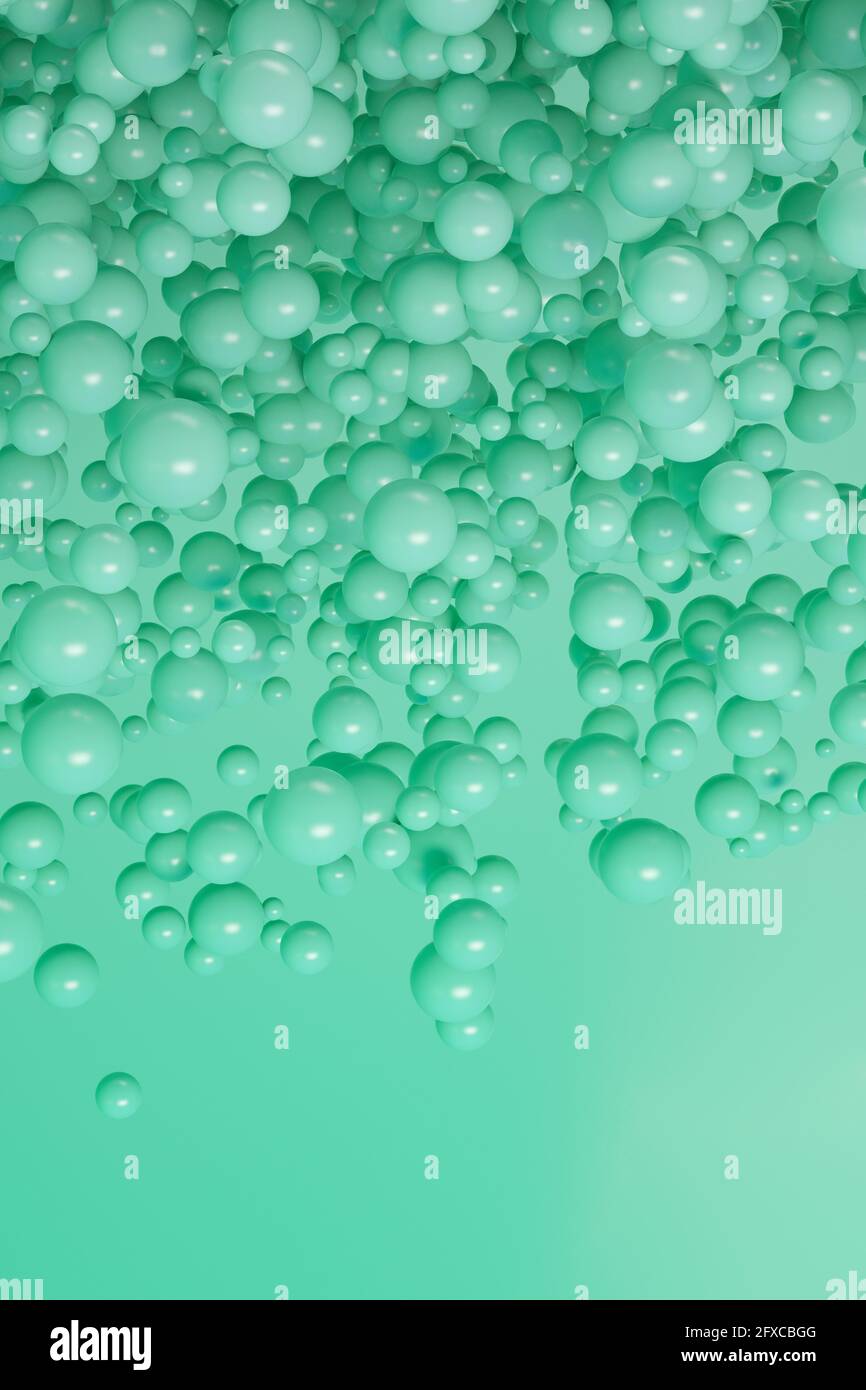 Rendu tridimensionnel des sphères vertes flottant sur fond vert Banque D'Images