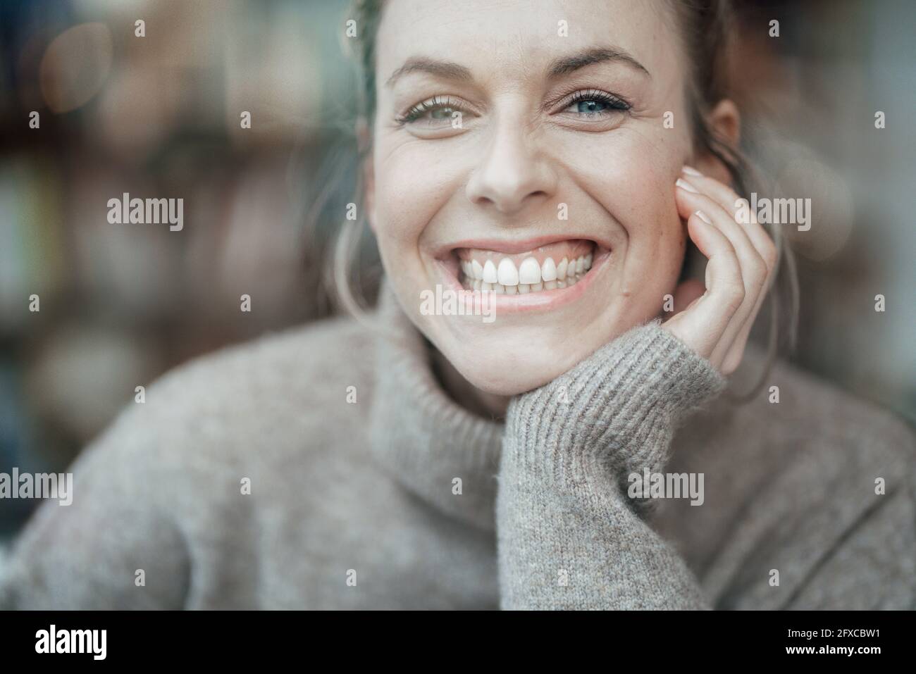 Belle femme avec un sourire éclatant au café Banque D'Images