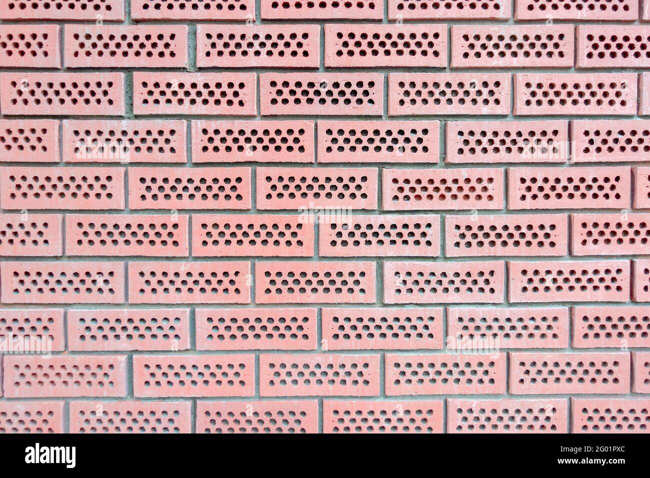 Arrière-plan mural en briques rouges perforées Banque D'Images