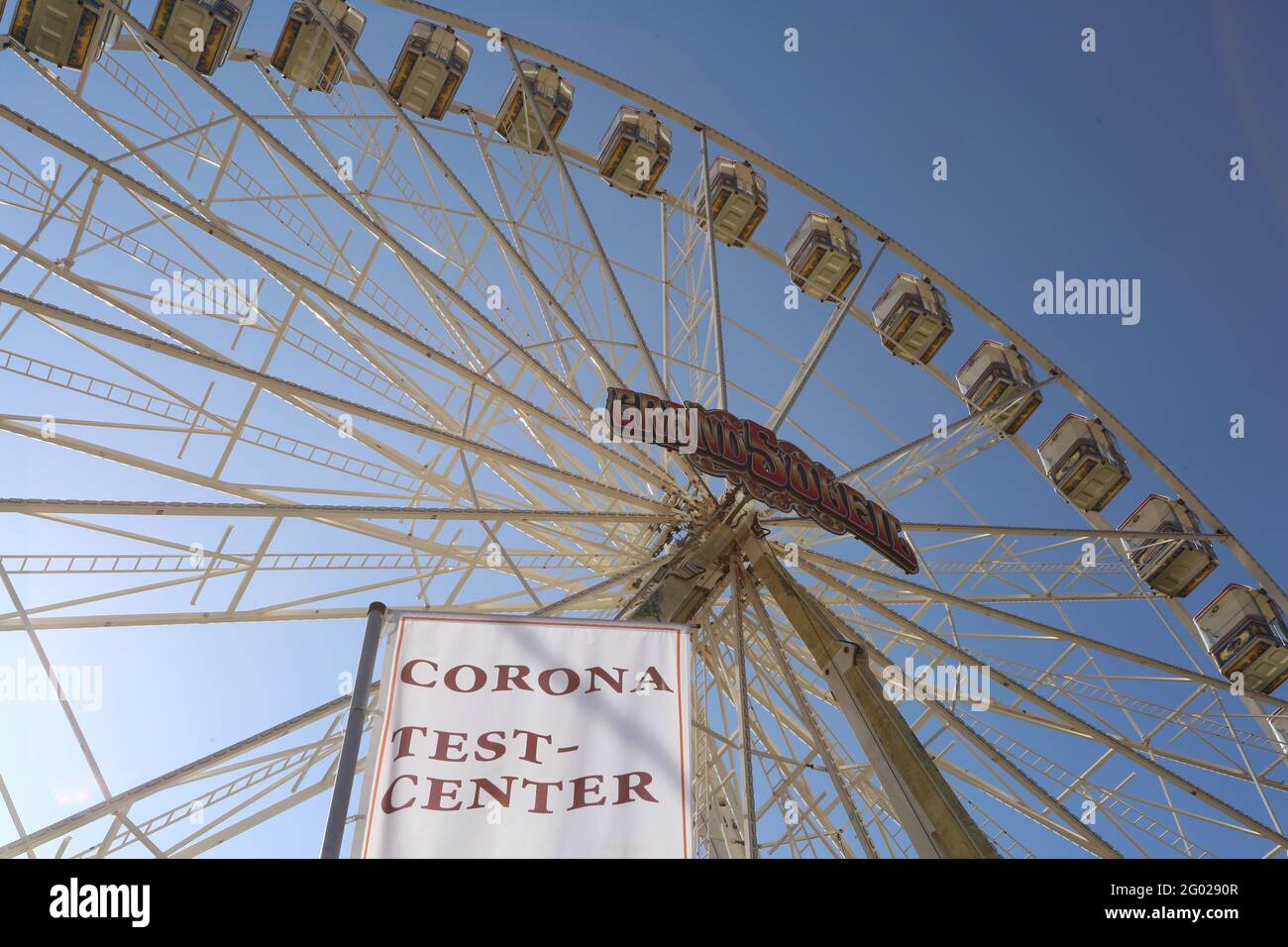 Wernigerode, Allemagne. 31 mai 2021. Une roue Ferris se trouve devant le drapeau d'un centre d'essai Corona. Probablement à partir de 4.6.2021 une grande roue de Ferris va tourner à nouveau dans les montagnes Harz. En raison de la pandémie de Corona, la roue de Ferris a dû être démantelée prématurément au cours du confinement l'an dernier. Après l'annulation de divers événements et festivals, l'industrie du showman peut respirer à nouveau lentement. Credit: Matthias Bein/dpa-Zentralbild/ZB/dpa/Alay Live News Banque D'Images