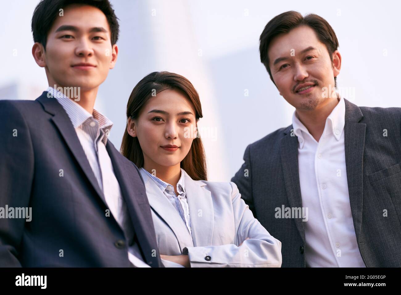 portrait extérieur de l'équipe de trois hommes d'affaires asiatiques prospères regarder l'appareil photo Banque D'Images
