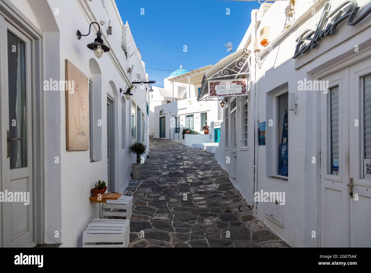 Grèce, île de Sifnos. 19 mai 2021. Architecture grecque traditionnelle bâtiments blanchis à la chaux et rues pavées étroites, journée ensoleillée, ciel bleu clair. C Banque D'Images