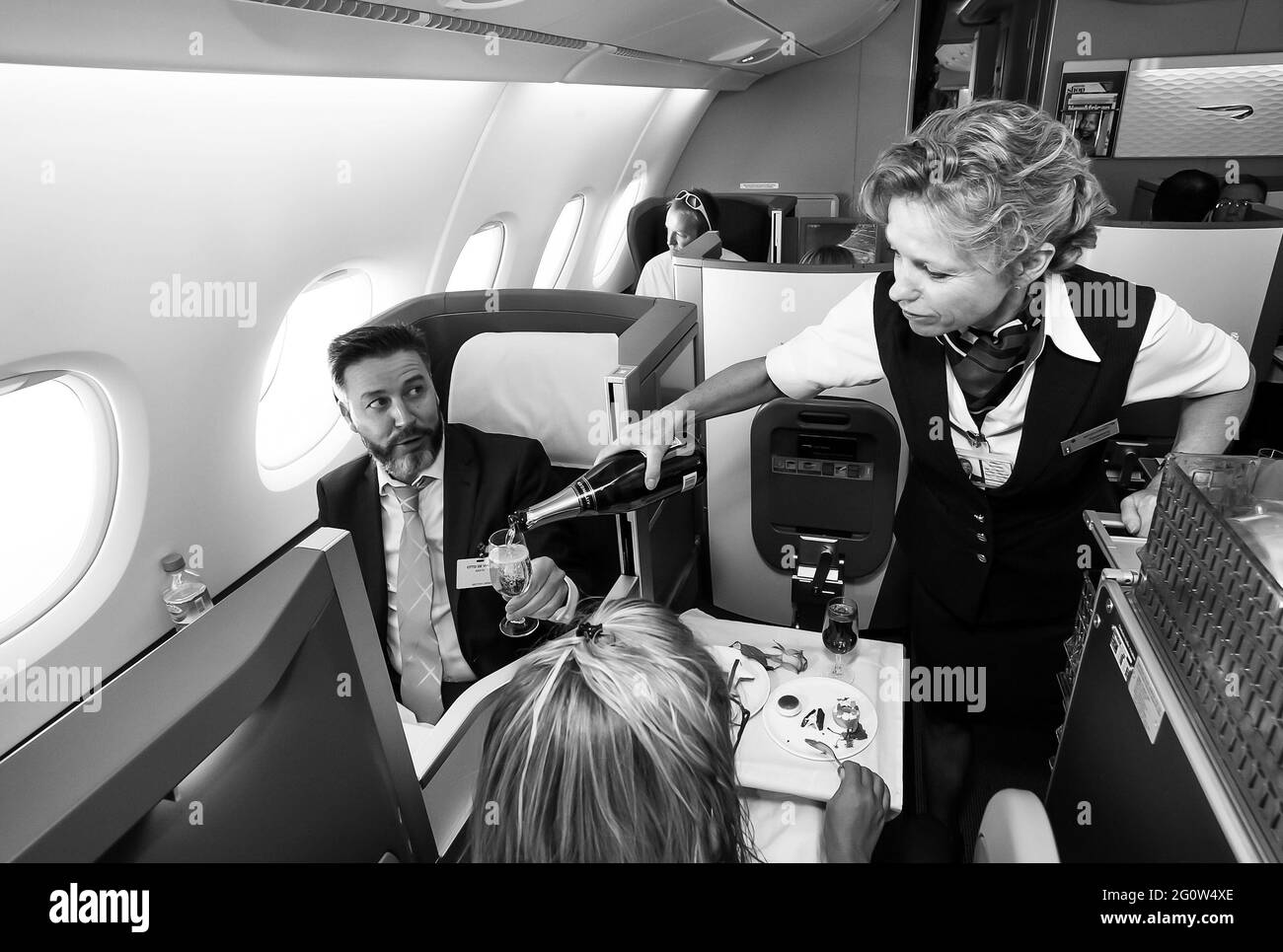 JOHANNESBURG, AFRIQUE DU SUD - 06 janvier 2021: Johannesburg, Afrique du Sud - 06 2014 février: Une femme de cabine verse un verre de champaign dans les affaires c Banque D'Images