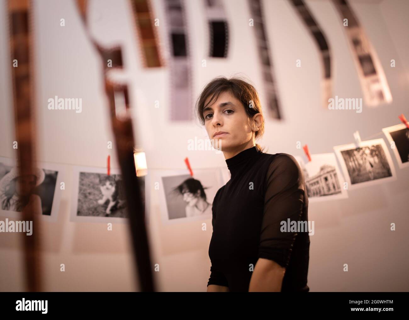 Portrait d'une jeune artiste créative féminine en studio photo. Femme dans un studio photographique traditionnel. Développement d'un concept de film pour caméra analogique. Banque D'Images