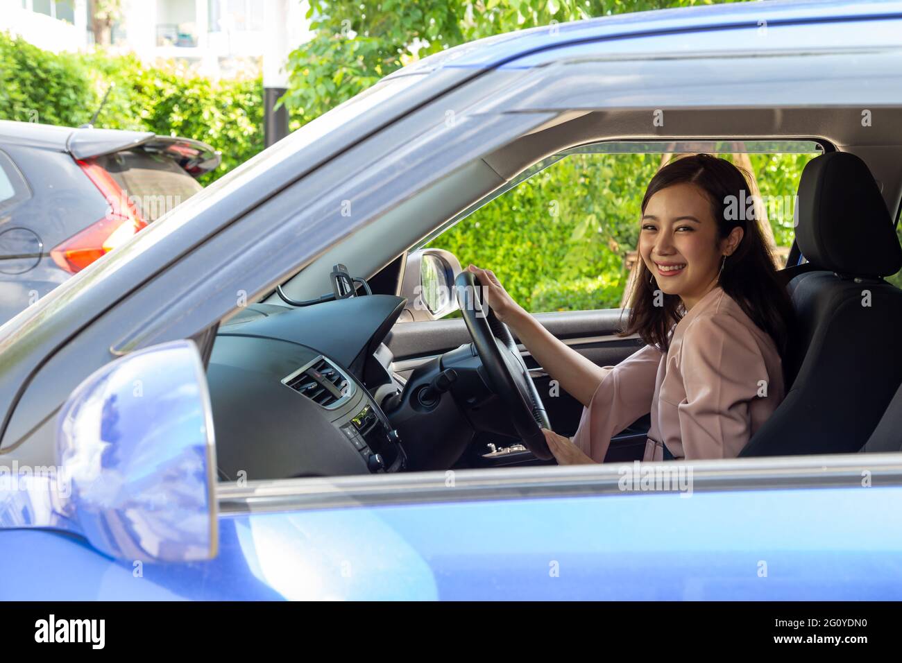 Les femmes asiatiques conduisant une voiture et sourire joyeusement avec heureuse expression positive au cours de la route de voyage, les gens aiment rire transports et rela Banque D'Images