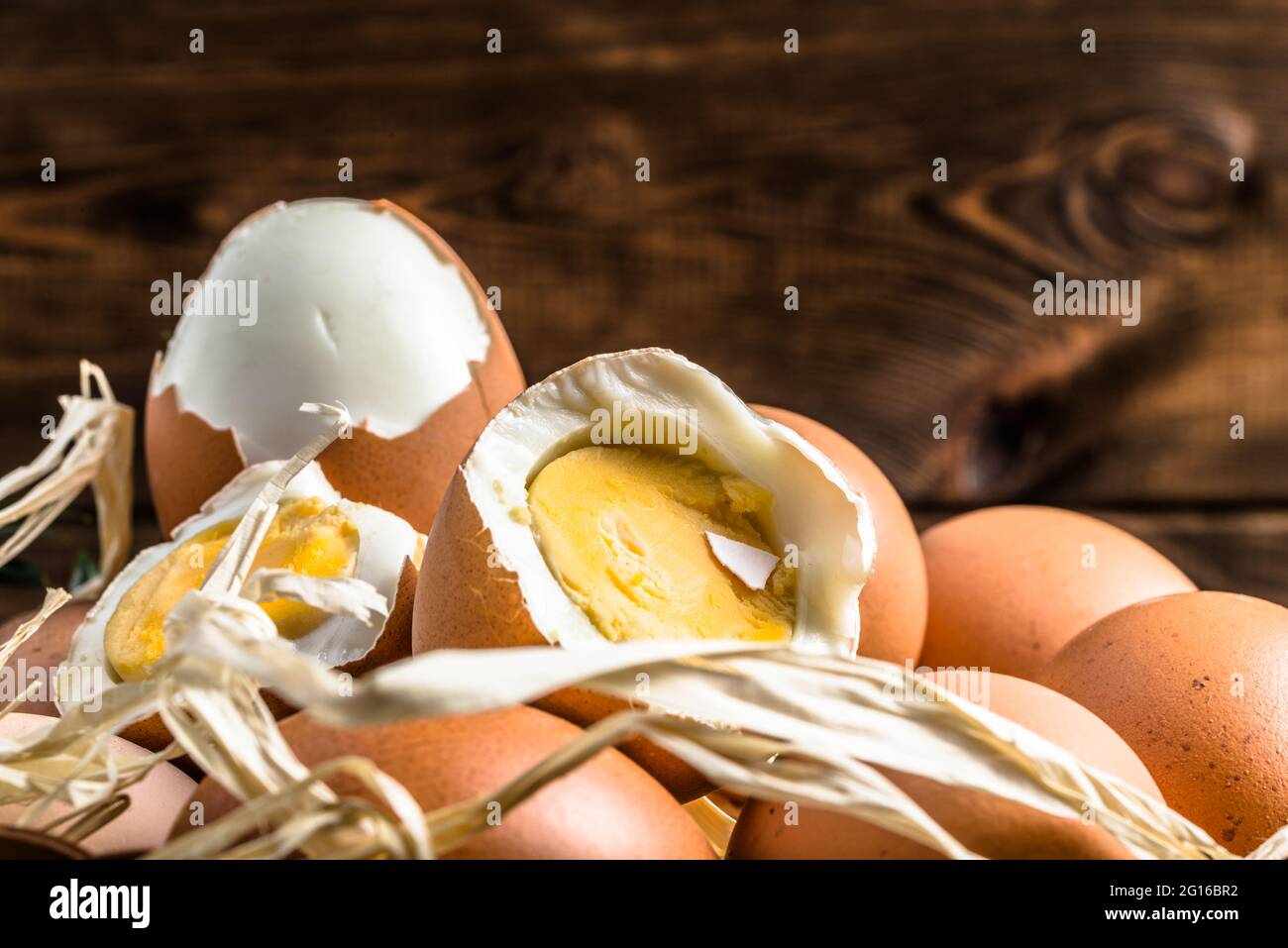 Œufs bio dans le panier et œuf dur avec jaune, concept alimentaire de saison de pâques Banque D'Images