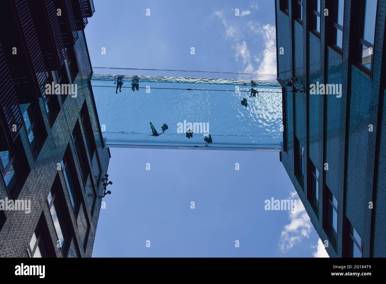 Londres, Royaume-Uni. 05e juin 2021. On voit des gens nager dans une piscine Sky Pool récemment ouverte à Londres. Une piscine entièrement transparente suspendue à 35 mètres au-dessus du sol entre deux immeubles d'appartements à côté de l'ambassade américaine à neuf Elms, la piscine Sky est considérée comme la première piscine du genre au monde et est ouverte aux résidents seulement. Crédit : SOPA Images Limited/Alamy Live News Banque D'Images