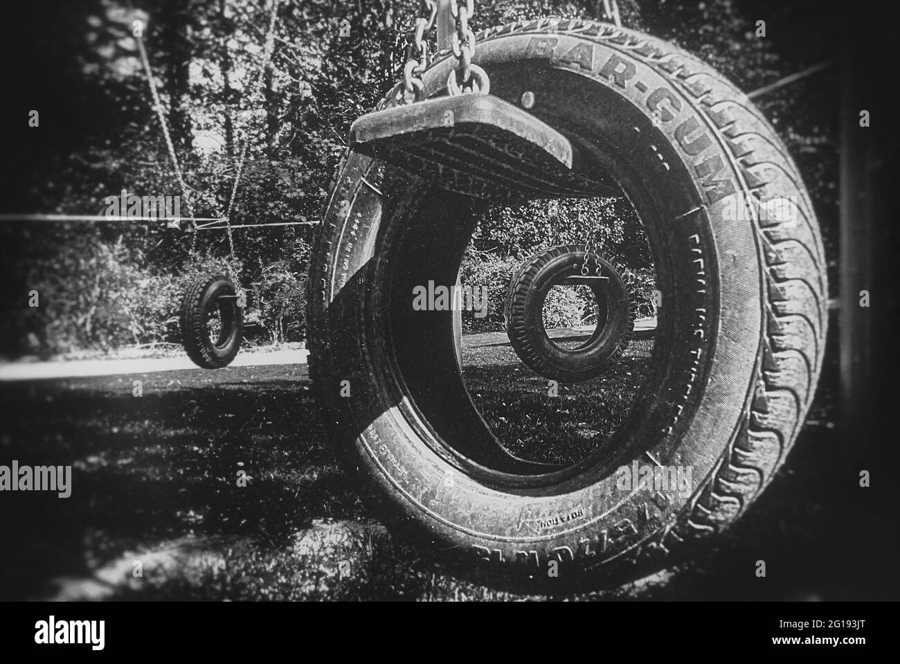 Les pneus de voiture comme un balancement dans le parc. Spirale et vortex comme métaphore surréaliste dans le tunnel de l'après-vie. Dans l'abîme à l'œil du tunnel. Banque D'Images