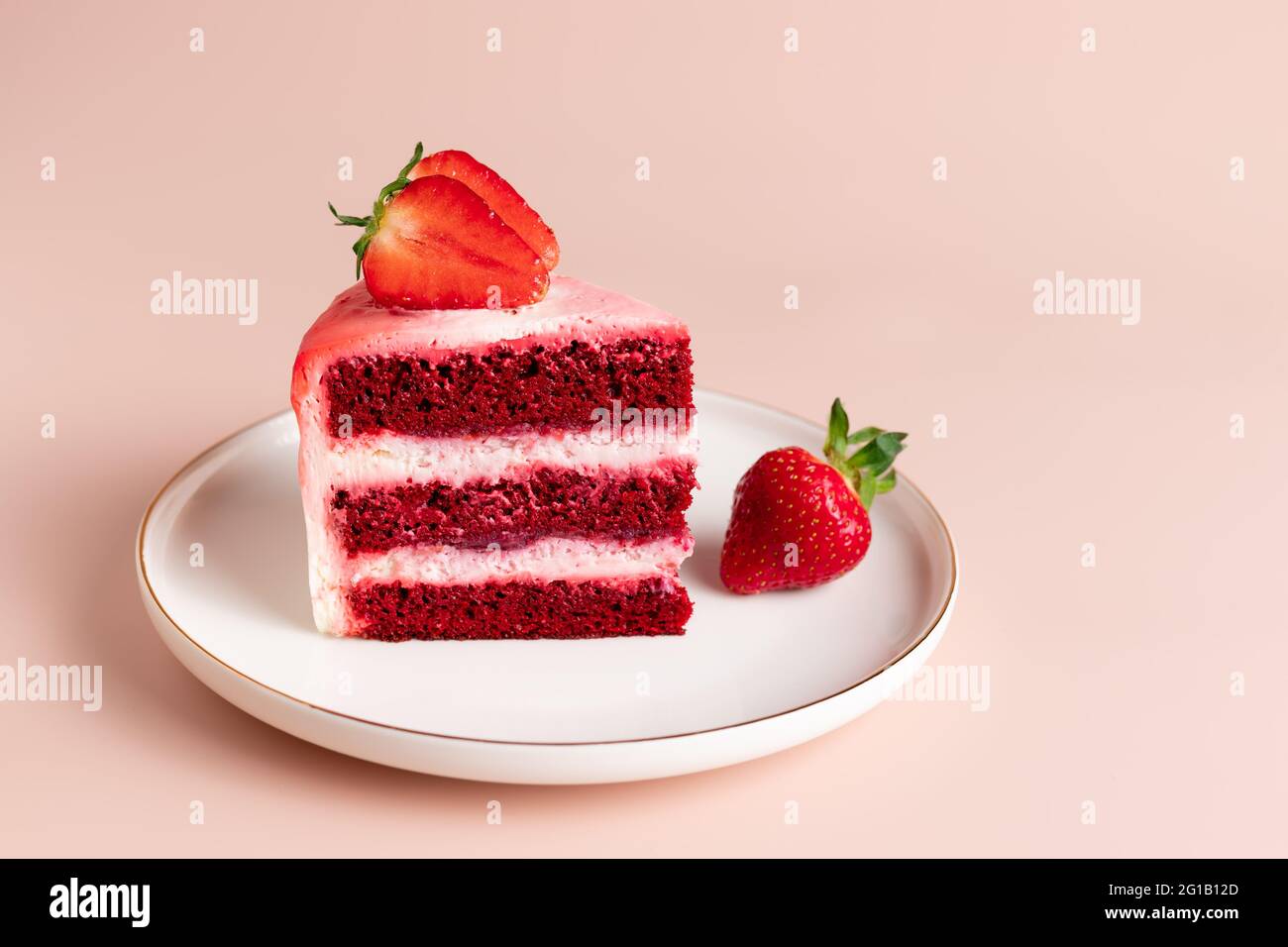 morceau de gâteau en velours rouge décoré de fraises fraîches Banque D'Images