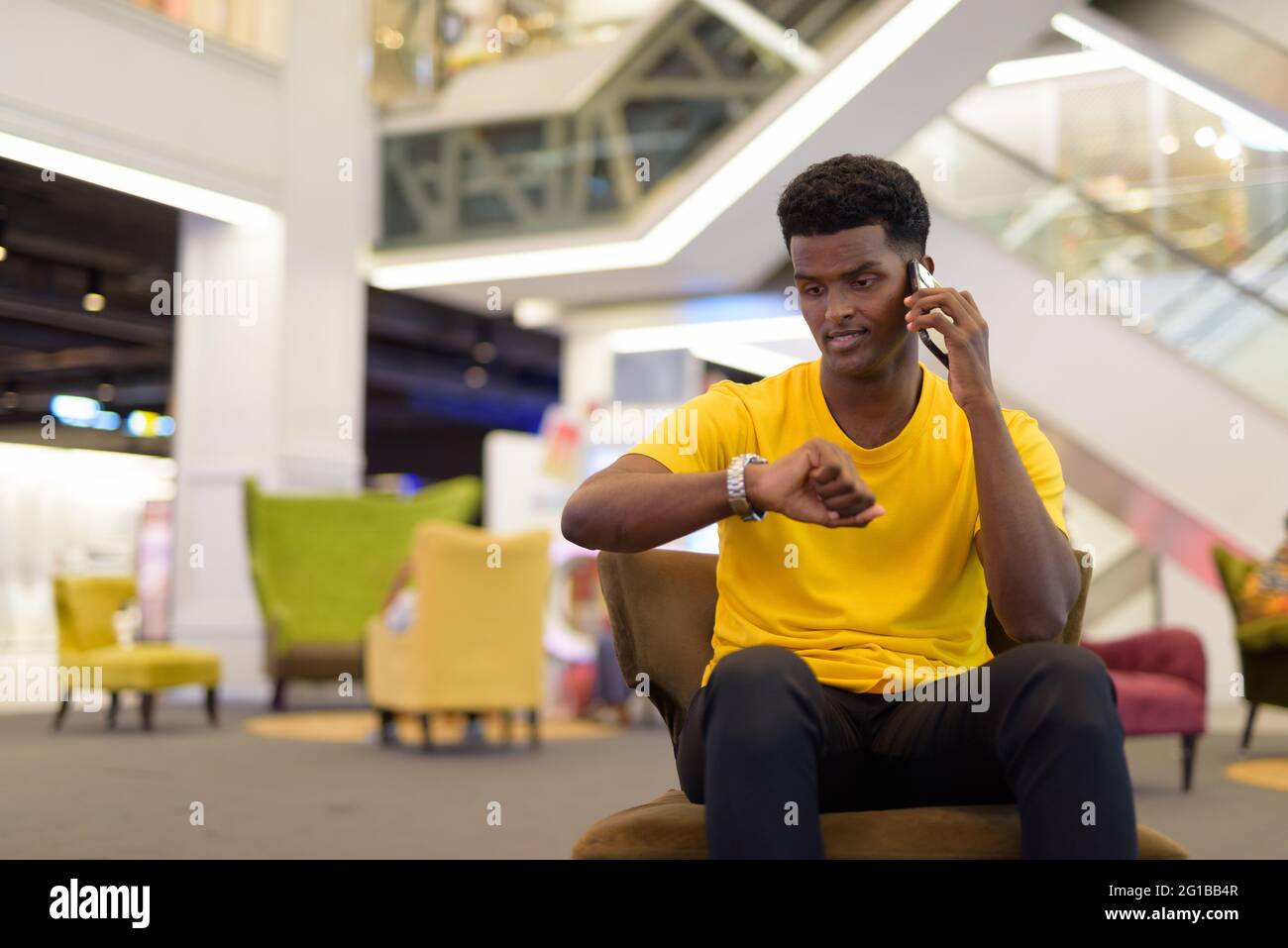 Portrait d'un beau homme africain noir portant un t-shirt jaune à l'intérieur Banque D'Images