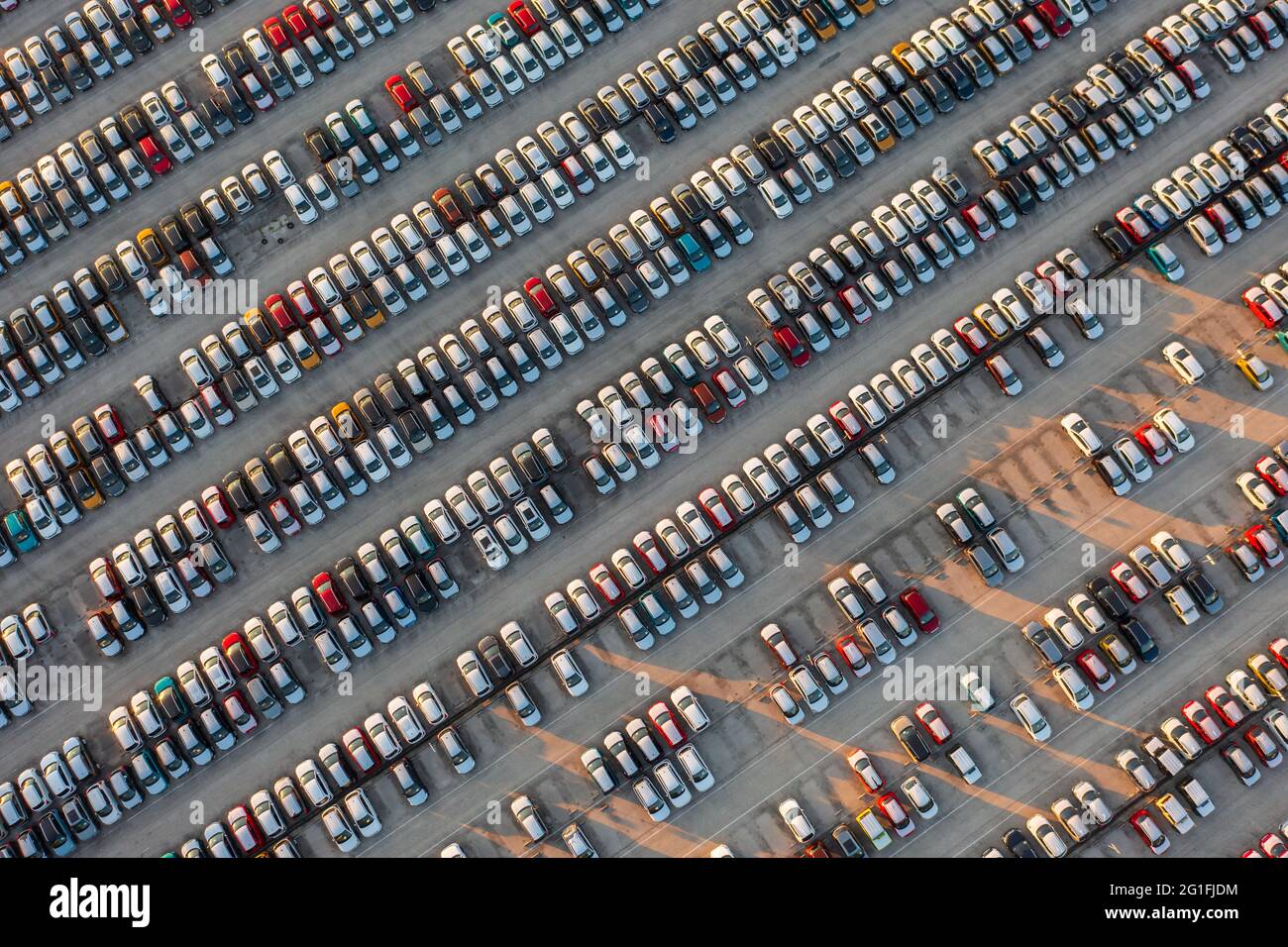 Vue aérienne de dessus vers le bas des voitures neuves au centre logistique, près de l'usine. Prêt à exporter ou importer. Parking. Banque D'Images