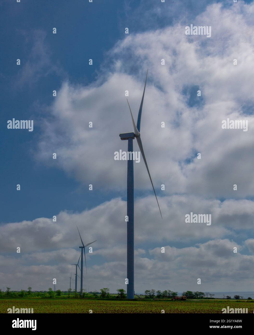 sur le fond d'un ciel bleu avec des nuages blancs, un générateur d'éolienne d'électricité verte sur le bord de mer Banque D'Images