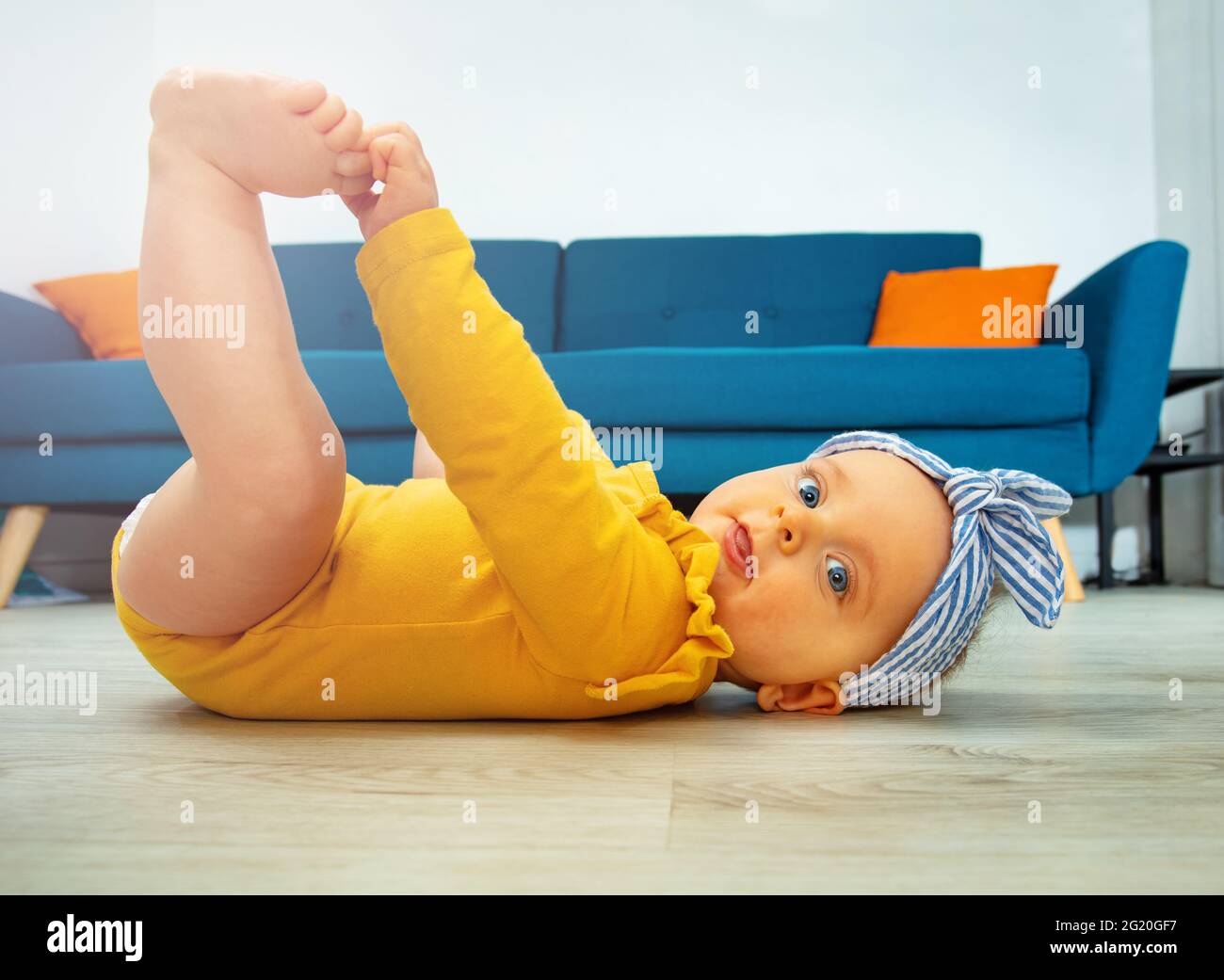 Photo De Profil D Une Petite Fille De Bebe Touchant Les Jambes Photo Stock Alamy