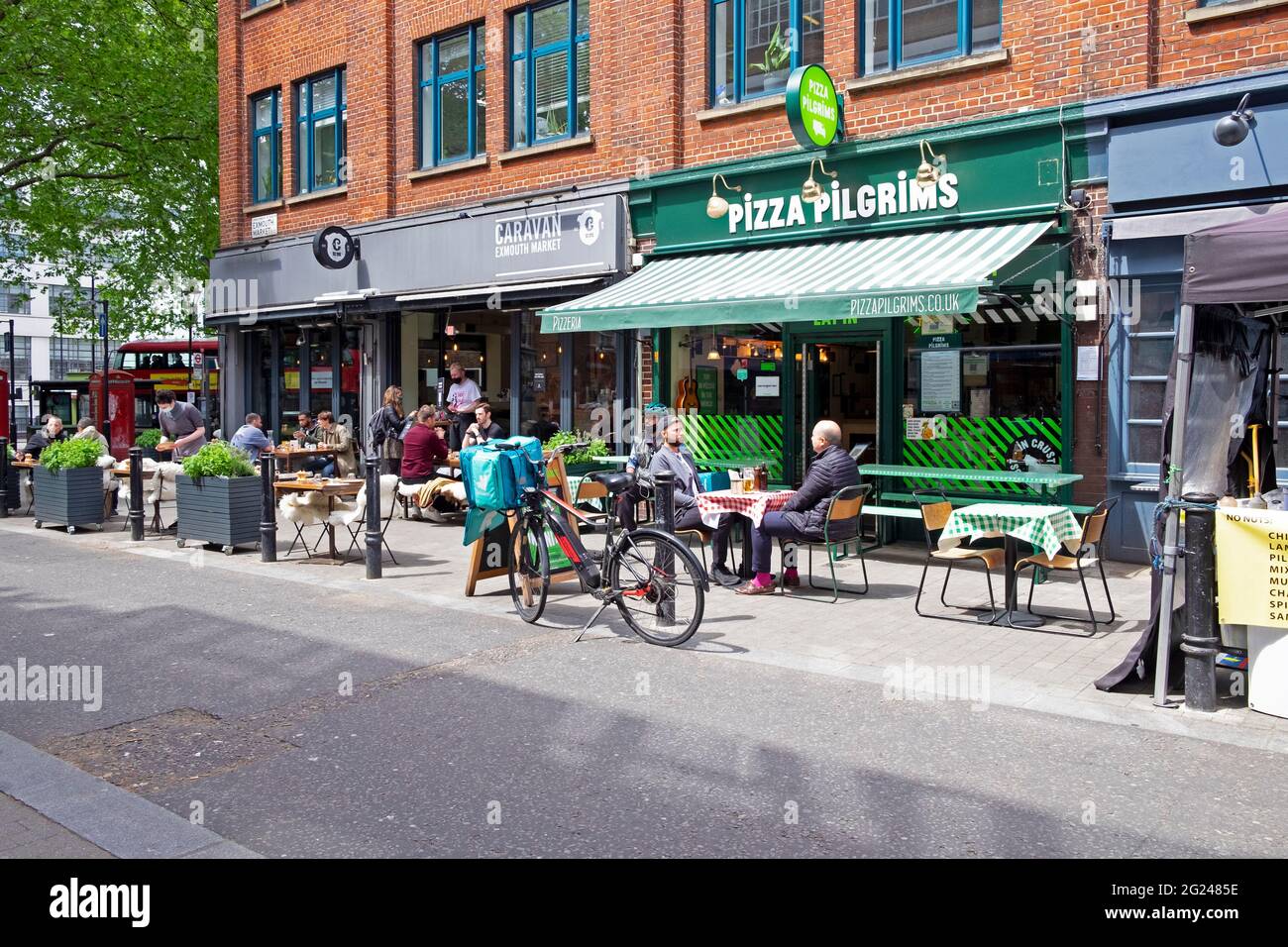 Personnes assises aux tables du restaurant Pizza Pilgrims and Caravan Exmouth Market Street à Clerkenwell Islington Londres EC1 Angleterre KATHY DEWITT Banque D'Images