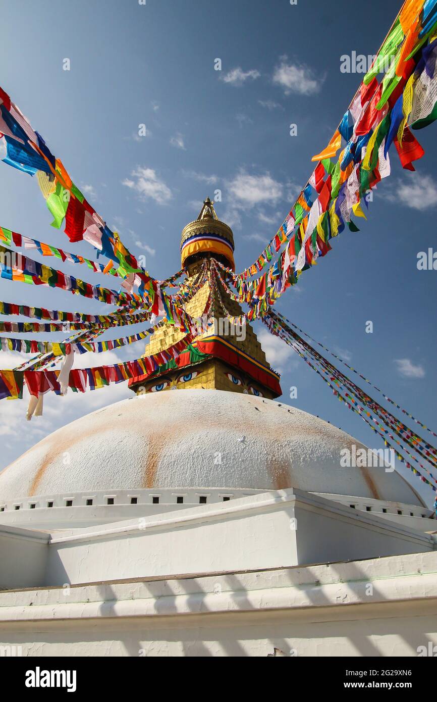 Vue sur le grand stupa blanc à Boudha, Katmandou. Il est drapé de drapeaux de prière colorés. Banque D'Images Vue sur le grand stupa blanc à Boudha, Katmandou. Il est drapé de drapeaux de prière colorés. Banque D'Images