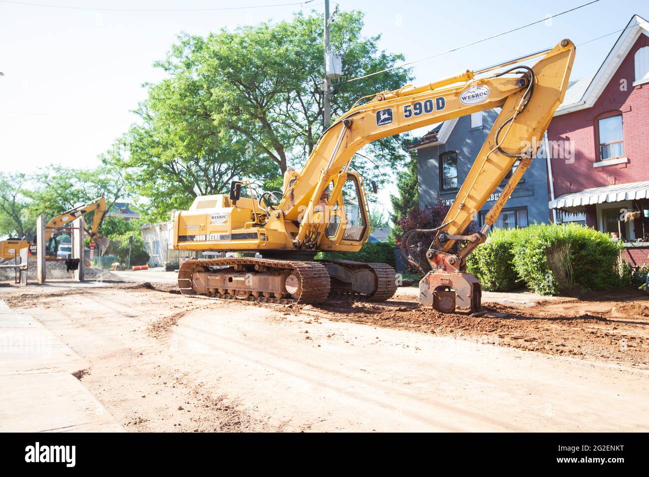 Des machines de construction à usage intensif travaillent sur la route pour le remplacement des tuyaux d'égout dans le centre-ville de Hamilton. Banque D'Images