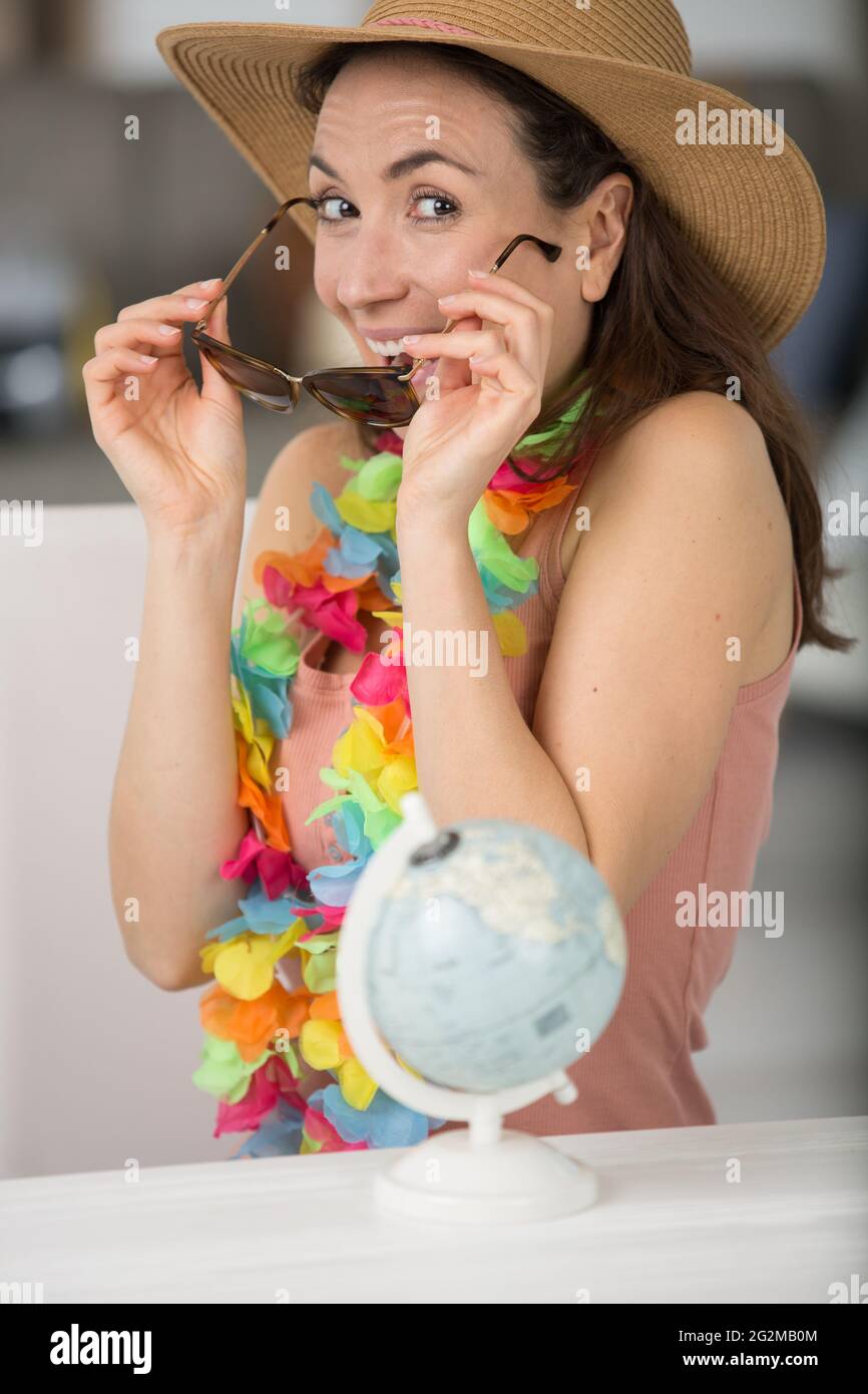 femme excitée par le monde entier mettant sur ses lunettes de soleil Banque D'Images