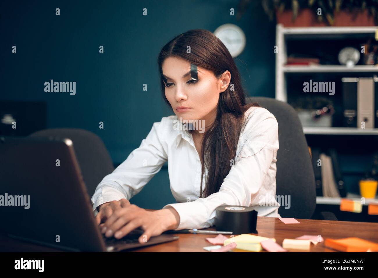 Femme essayant de garder les yeux ouverts pendant le travail. Banque D'Images