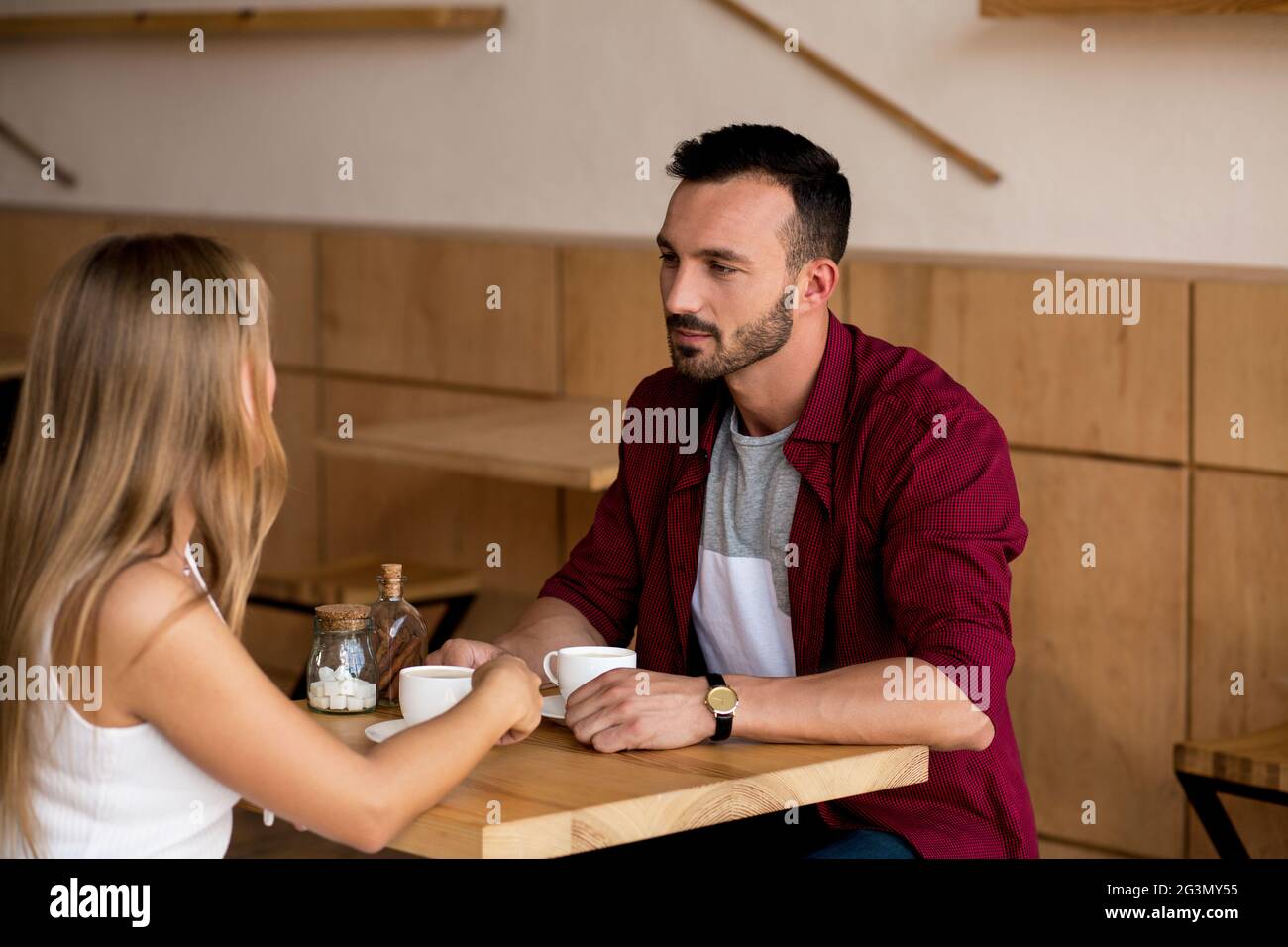 Cute couple having coffee together in cafe Banque D'Images