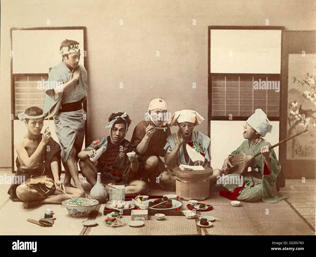 Photo d'époque Kusakabe Kimbei du Vieux-Japon - Working Men's Holiday. Un groupe d'hommes japonais appréciant une fête. Banque D'Images