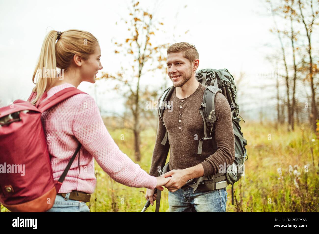 Date romantique pour couple de routards dans la nature sauvage. Les hommes et les femmes heureux se tiennent les uns les autres en tenant les mains contre Banque D'Images