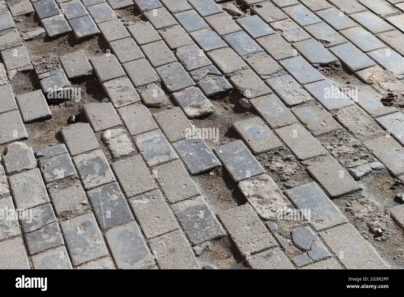 Ancienne route pavée endommagée, chaussée de rue en béton, photo de fond abstraite Banque D'Images