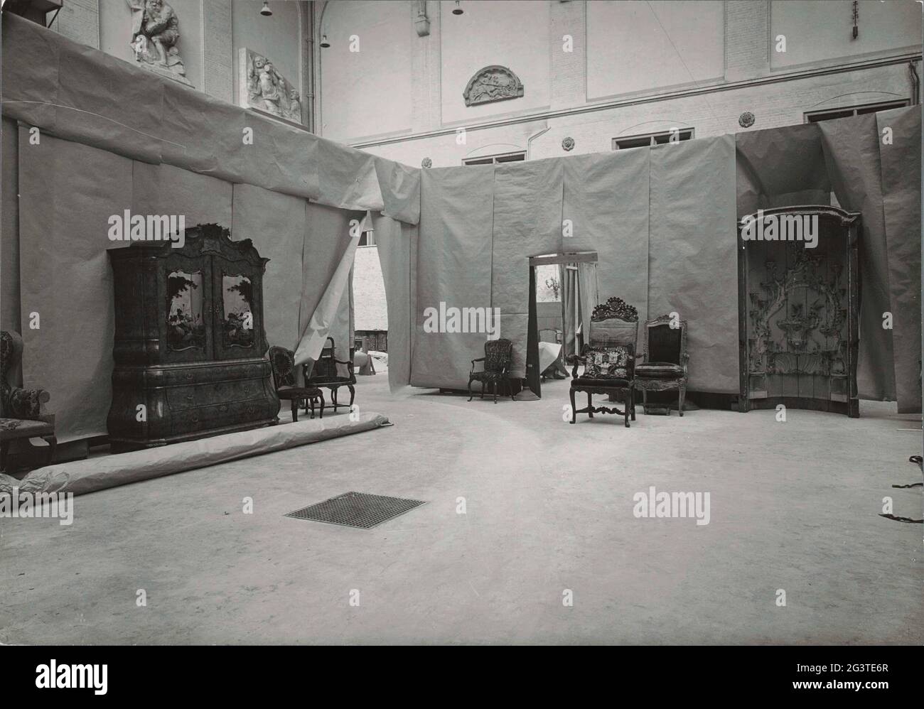 La cour ouest avec un arrangement de test de mobilier en 1955. Une réorganisation radicale de la possession du musée ne pouvait pas avoir lieu avant que les possibilités des différentes salles soient étudiées au moyen de configurations d'essai. C'est pourquoi, à l'hiver 1956-1957, les halls de la cour ouest ont été provisoirement conçus pour voir quelles exigences les rénovations devraient satisfaire. Pour cette installation de test, de grandes feuilles de papier et de longs chiffons ont été déposés dans les espaces dans lesquels il avait été exposé dans le musée en grande partie, l'art et l'artisanat du XVIIIe siècle, qui n'a jamais été à voir dans le Banque D'Images