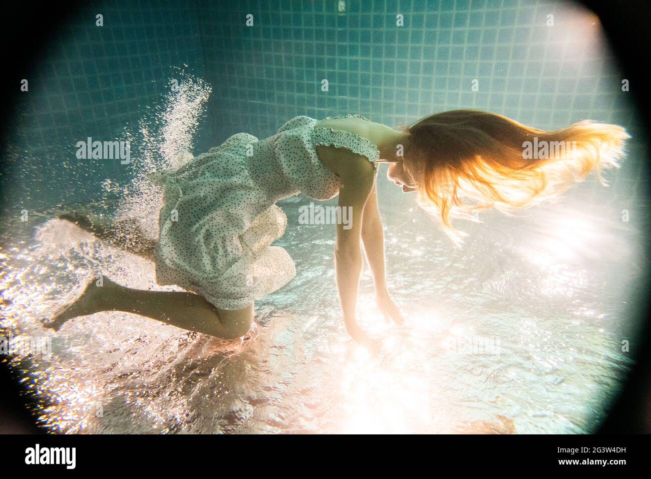 Belle femme sous l'eau en robe blanche Banque D'Images