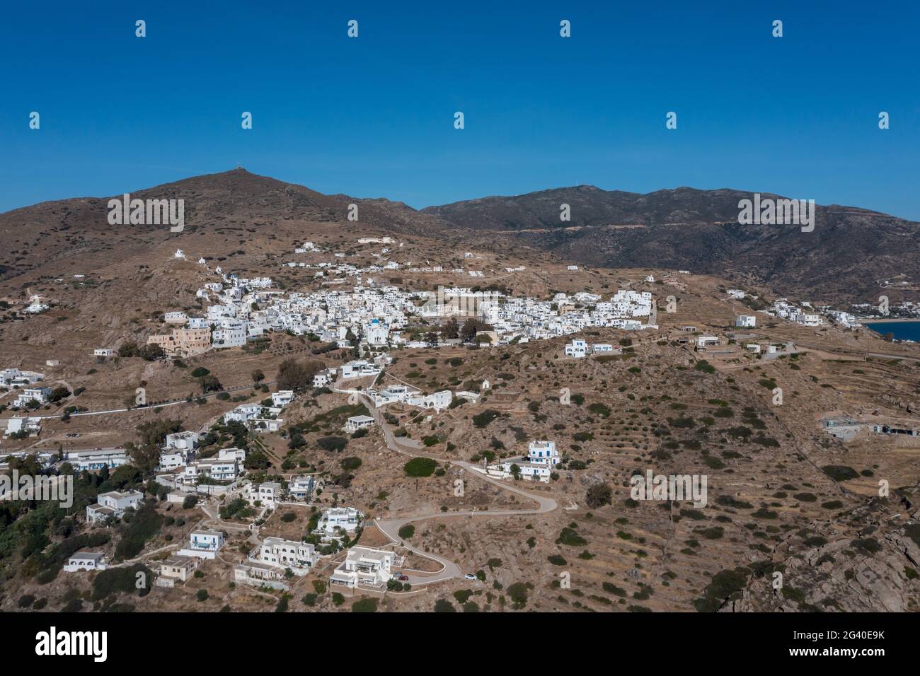 Îles Cyclades iOS, Grèce. Vue aérienne sur la ville de Chora. Architecture traditionnelle des Cyclades, bâtiments blanchis à la chaux sur les terres rocheuses, ciel bleu ba Banque D'Images