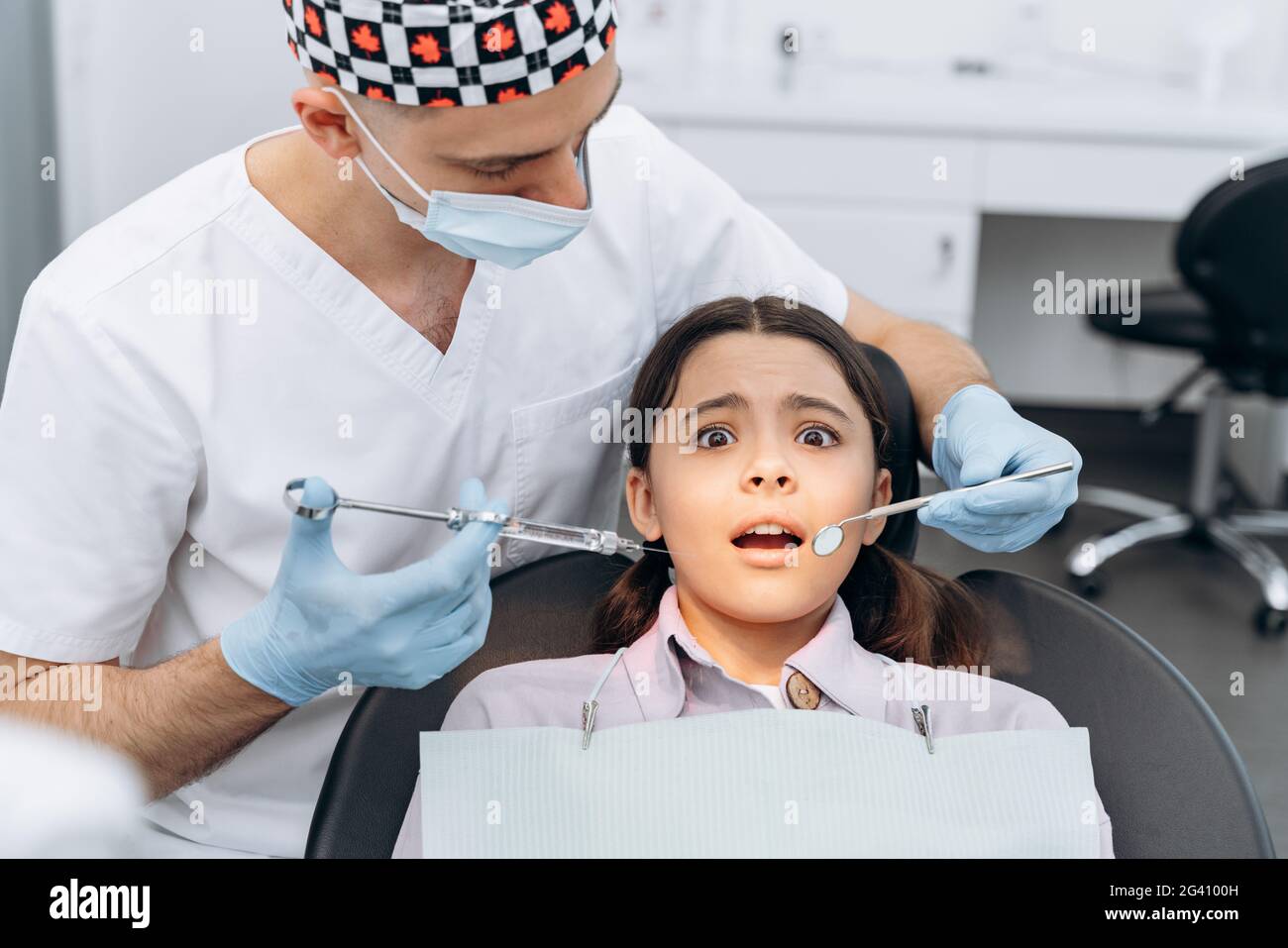 Fille Effrayee Dans Une Chaise Dentaire Peur De L Injection Le Dentiste Tient Une Seringue Avec Une Aiguille Dans Sa Main Photo Stock Alamy