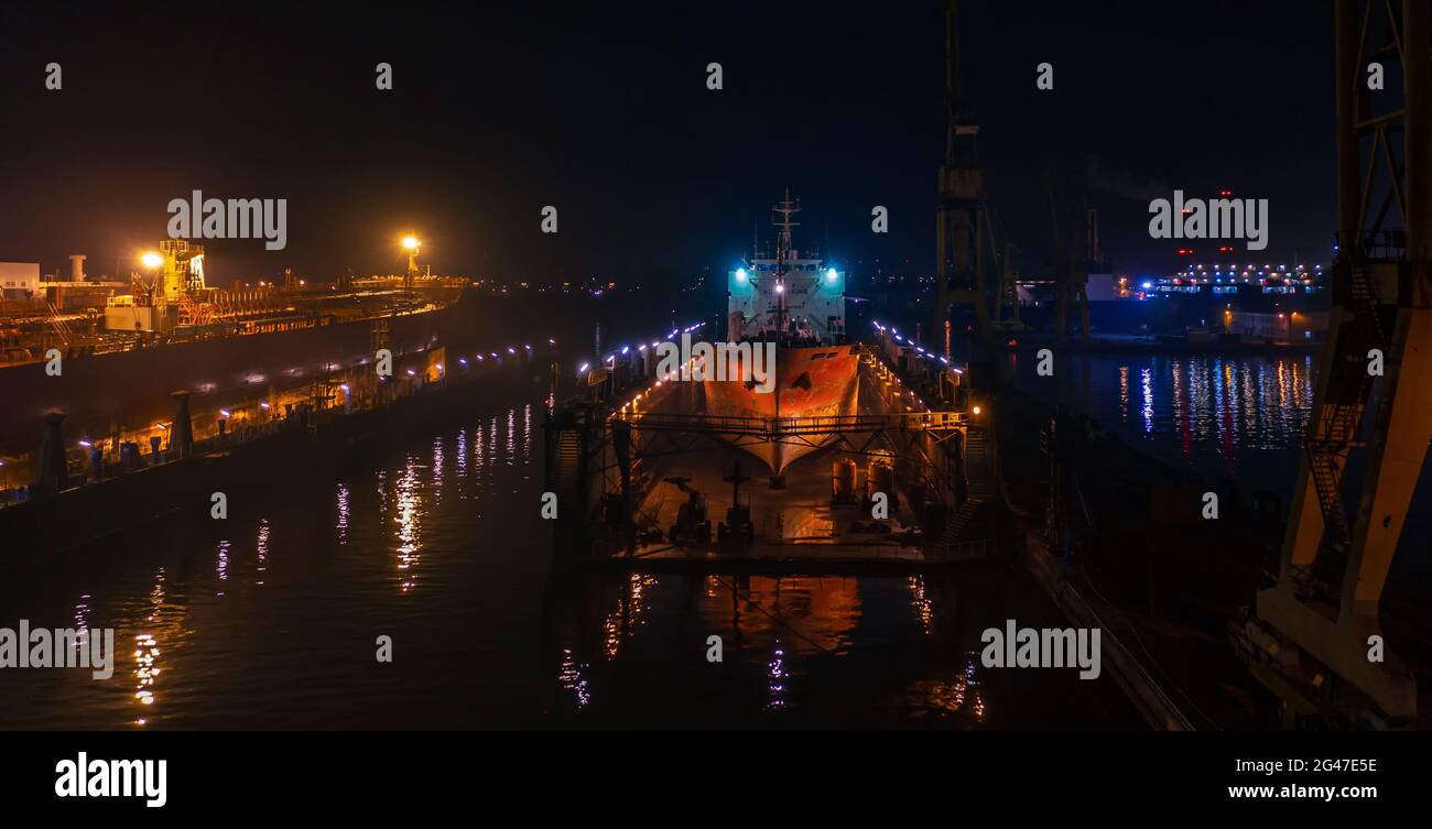 Photo de nuit le chantier naval de Remontova avec des navires dans des quais secs. Pologne, Gdansk, images de drones, lumière naturelle. Banque D'Images
