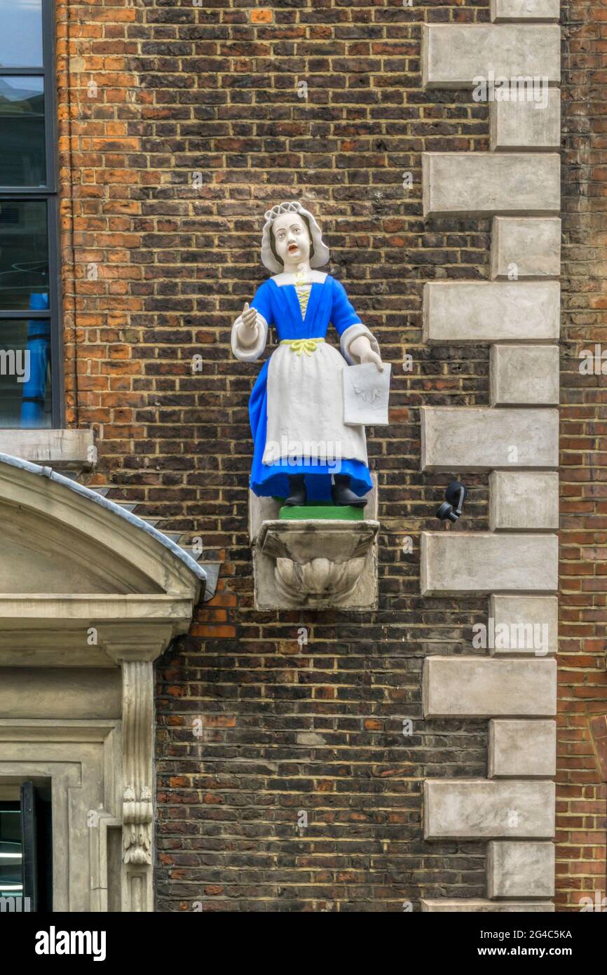 Statue de la jeune fille à l'extérieur de l'entrée de l'ancienne école de charité à Hatton Garden, Londres. Banque D'Images
