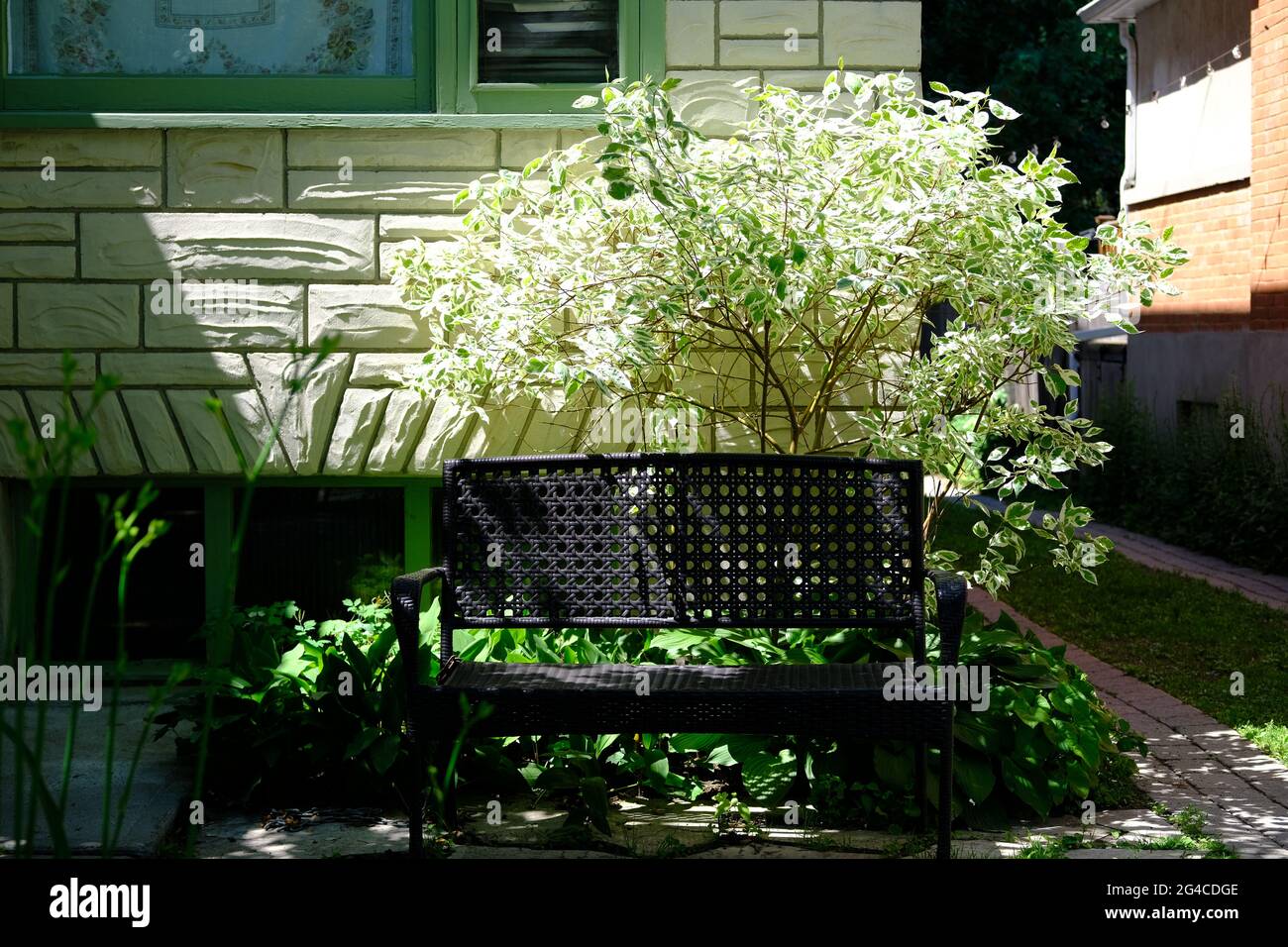 Banc en métal noir dans le jardin d'une propriété résidentielle à Ottawa, Ontario, Canada. Banque D'Images