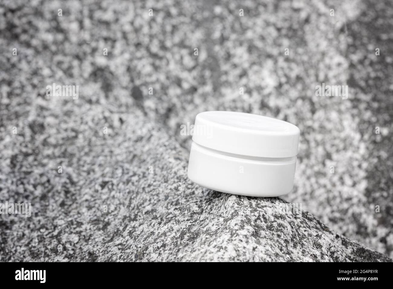 Crème pour les mains, crème hydratante, lotion dans un pot en plastique blanc sur la vue avant en pierre grise. Modèle de produit cosmétique anti-âge, soin du corps de luxe et organique Banque D'Images
