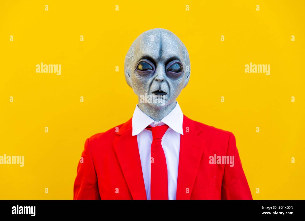 Portrait d'un homme portant un costume étranger et un costume rouge vif Banque D'Images