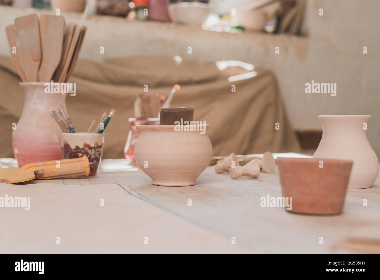 pots en argile faits main avec équipement de poterie sur table en bois Banque D'Images