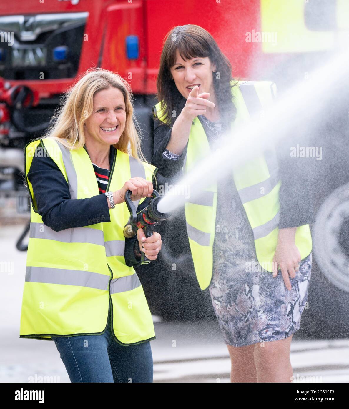 Rachel Reeves, la chancelière fantôme (à droite), regarde comme le candidat travailliste à la Batley et à l'élection partielle de spen, Kim Leadbeater, utilise un tuyau d'incendie, lors d'une visite à Angloco, Qui fabrique des moteurs d'incendie et des véhicules de secours utilisés dans tout le pays et dans le monde, alors que sur la piste de campagne avant l'élection partielle du 1er juillet. Date de la photo: Jeudi 24 juin 2021. Banque D'Images