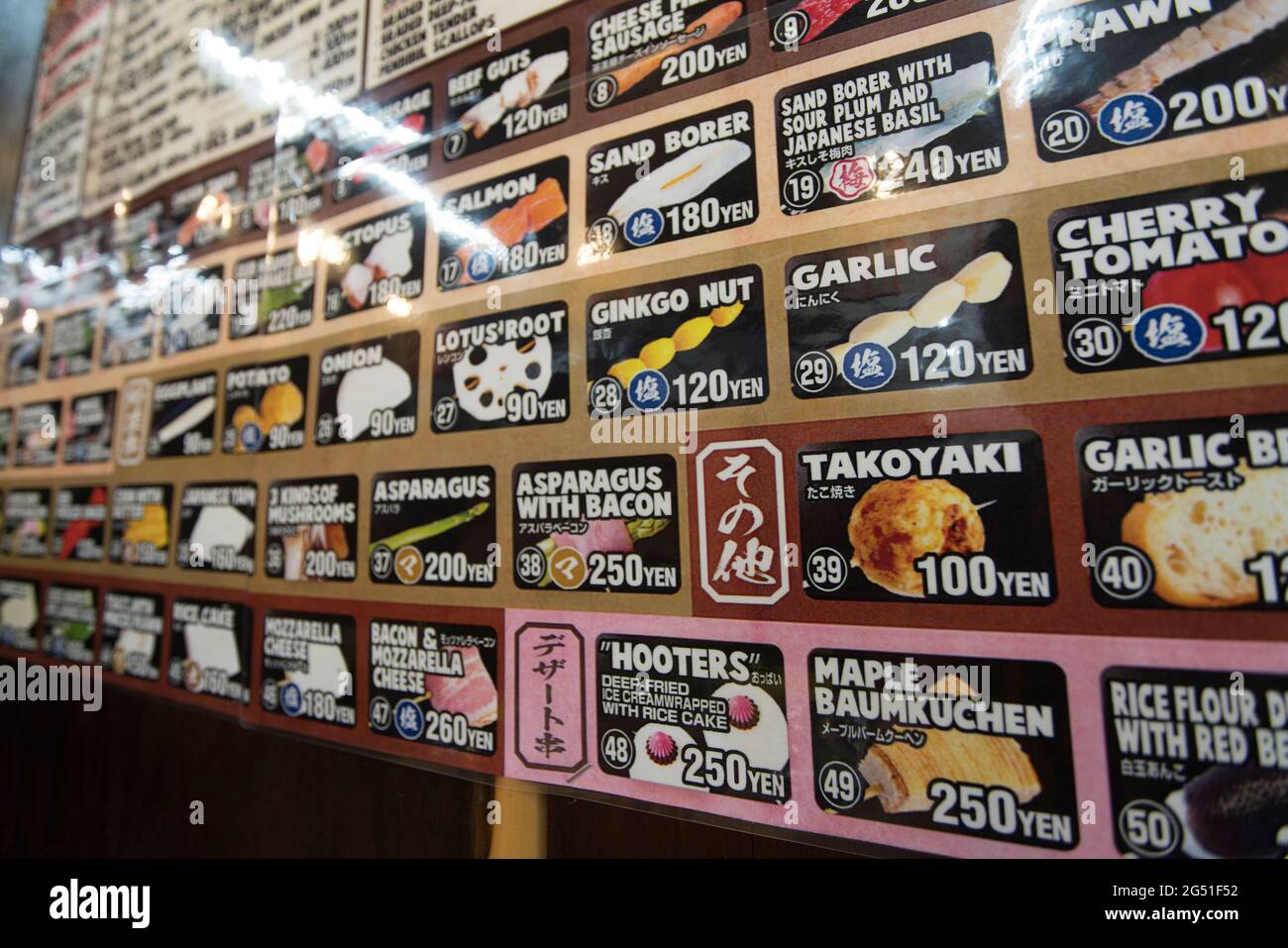 Un menu sur un mur d'un restaurant yakitori à Osaka, Japon Banque D'Images